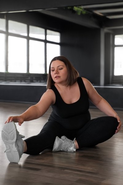 woman performing intense HIIT workout in living room to lose body fat fast