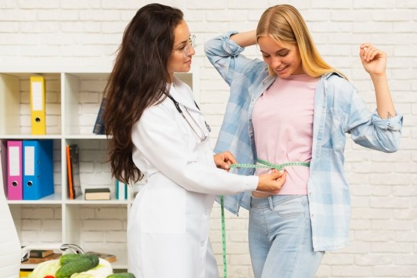 Smiling woman celebrating results at a weight loss clinic USA