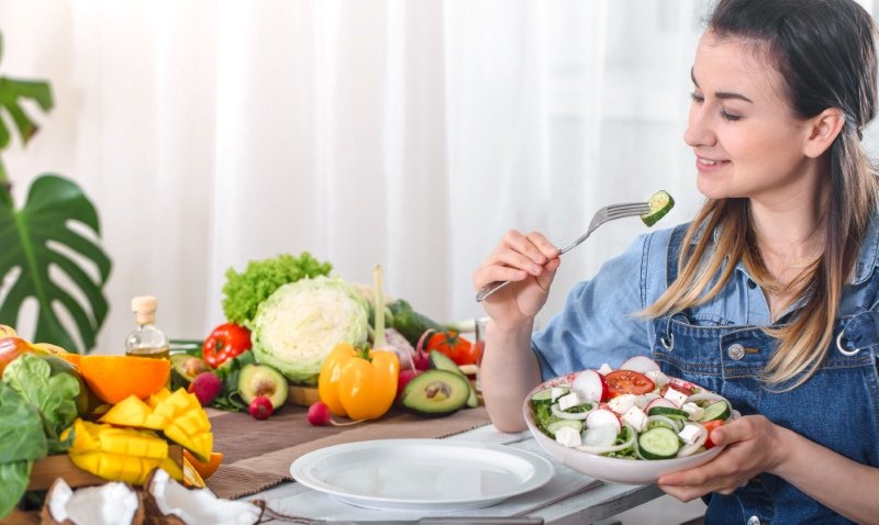 Adult enjoying a colorful balanced meal with fruits and vegetables for daily energy