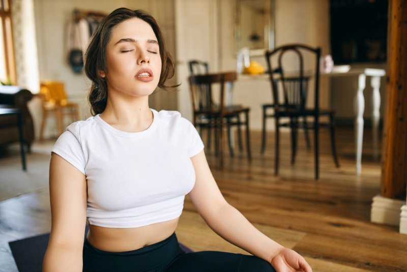 Person practicing Best Meditation for Stress and Anxiety USA through mindful breathing at home