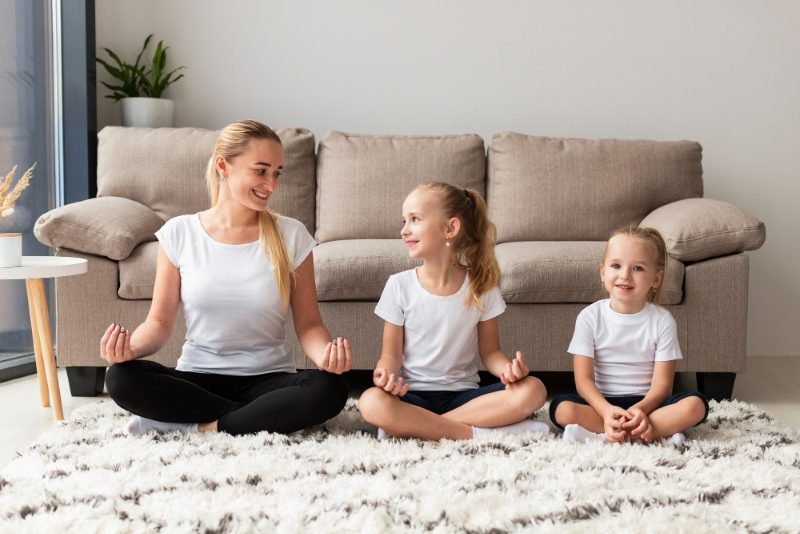 Healthy lifestyle tips for UK families: UK family practicing mindfulness and meditation at home