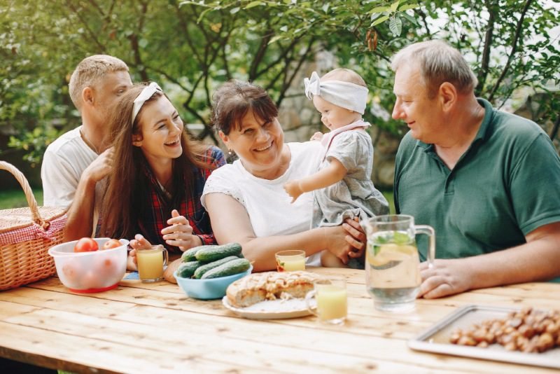 Healthy lifestyle tips for UK families: Happy UK family enjoying balanced meals, outdoor activities, and family wellness